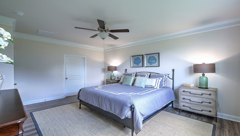 Bedroom with vinyl flooring, large window, and ceiling fan