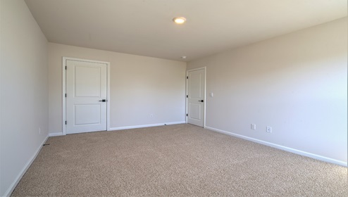 Carpeted bedroom with two large windows
