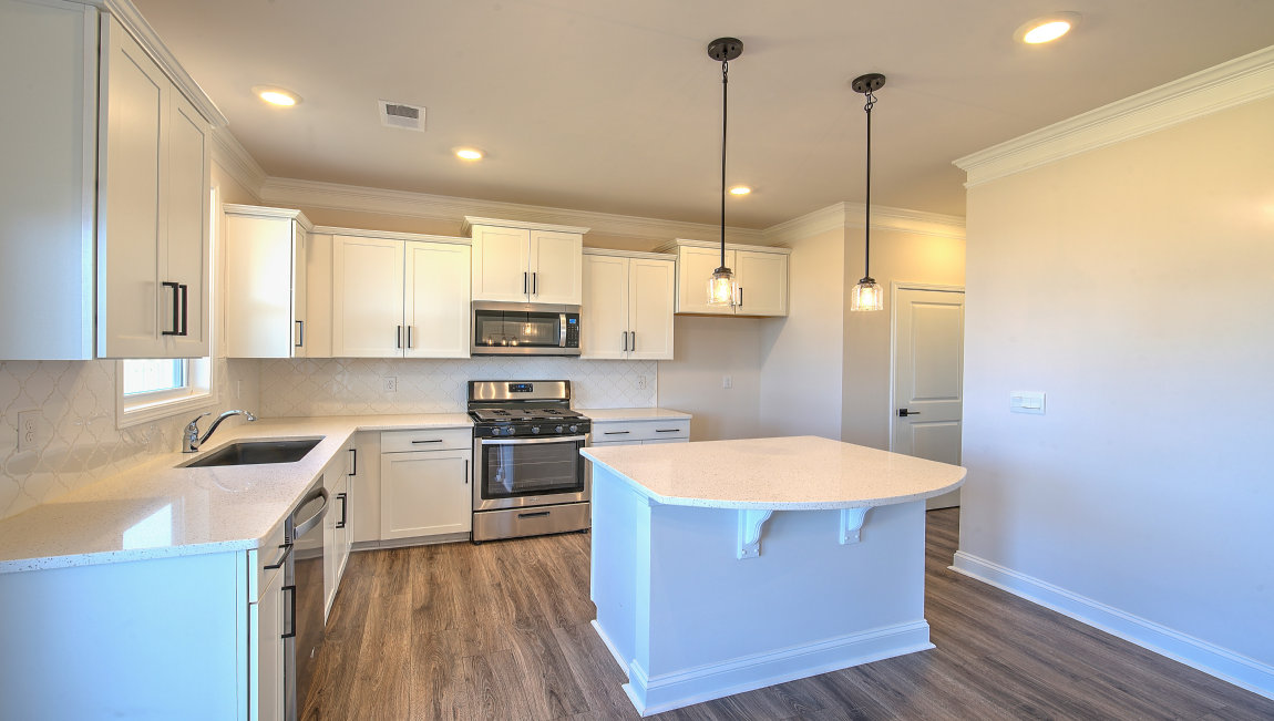 Kitchen and island, white cabinets and counters