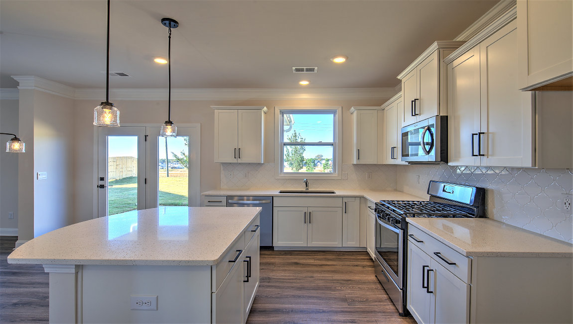 Kitchen and island, white cabinets and counters