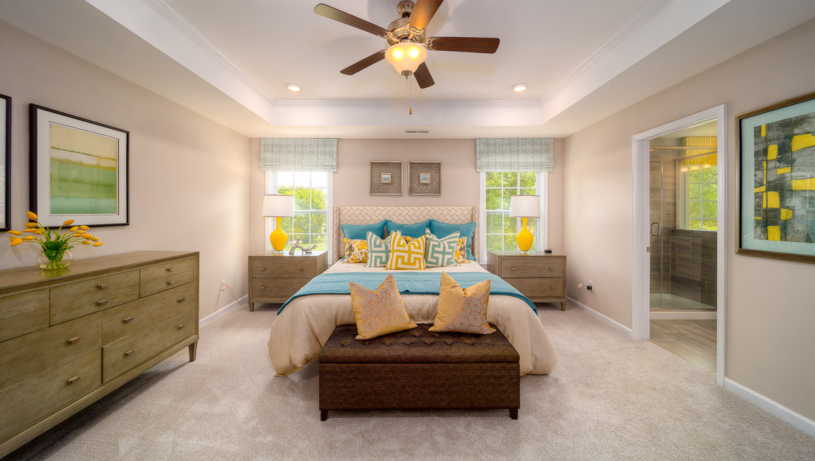 Primary suite carpeted with two windows