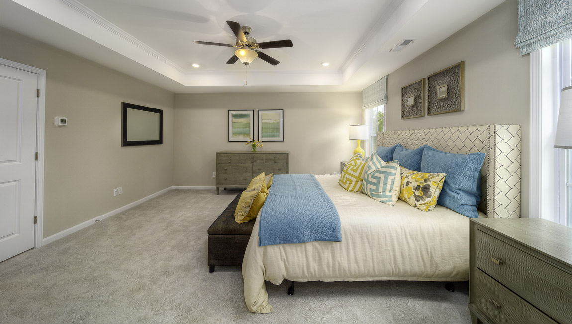 Primary suite carpeted with two windows