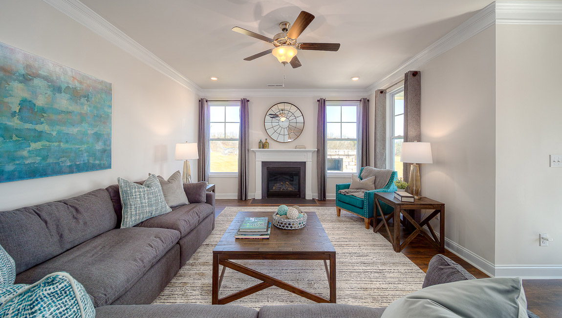 Open family room with two large window and fireplace