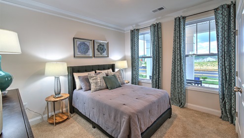 Carpeted bedroom with two windows