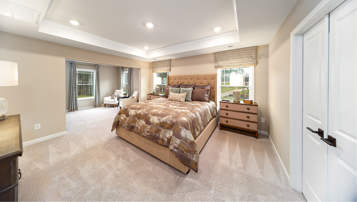 Primary bedroom, carpeted with two large windows
