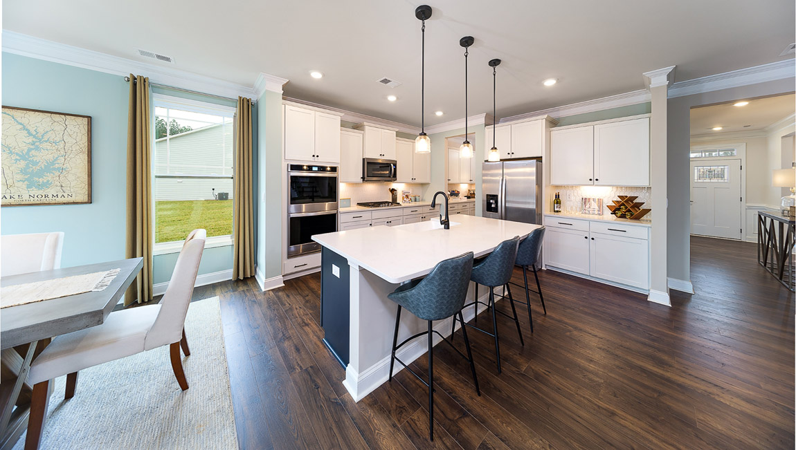 Kitchen and island with white cabinets