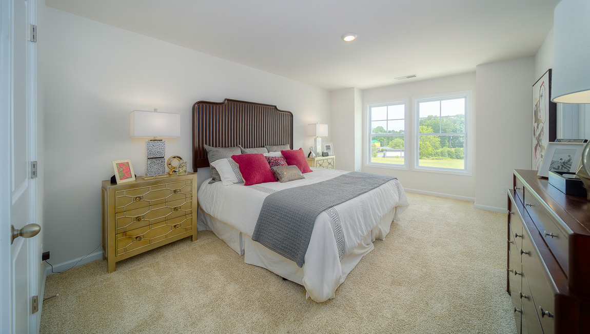 Primary bedroom with large windows