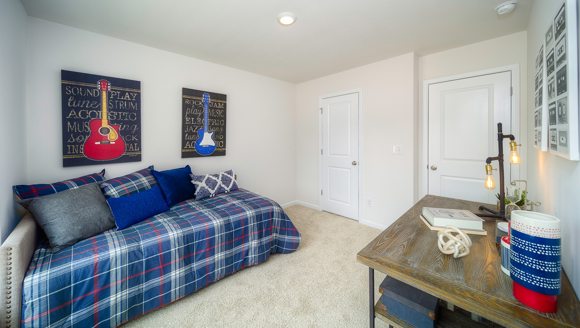 Carpeted bedroom with large windows