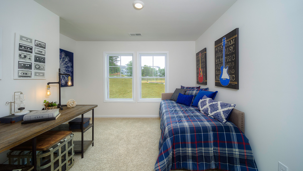 Carpeted bedroom with large windows
