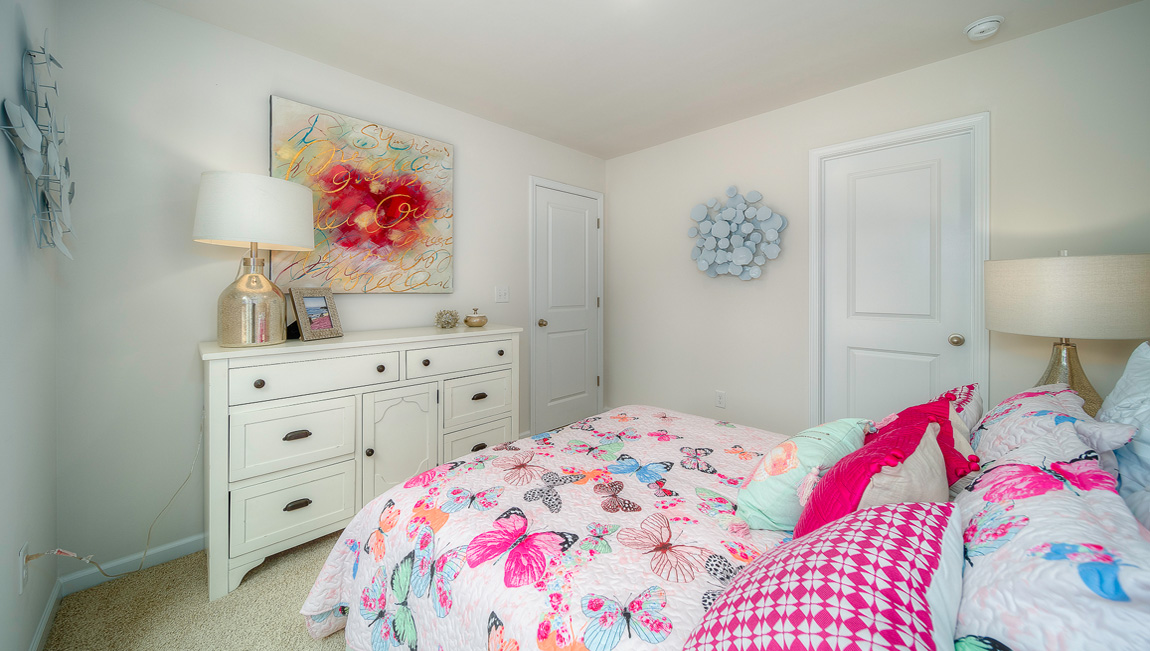 Carpeted bedroom with two small windows