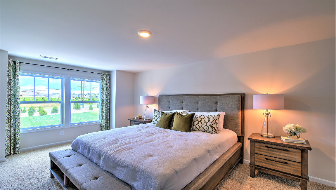 Carpeted bedroom with large windows