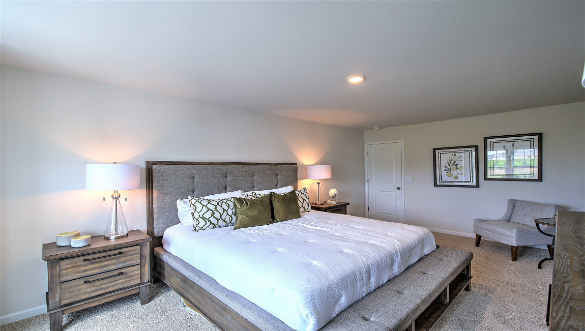 Carpeted bedroom with large windows