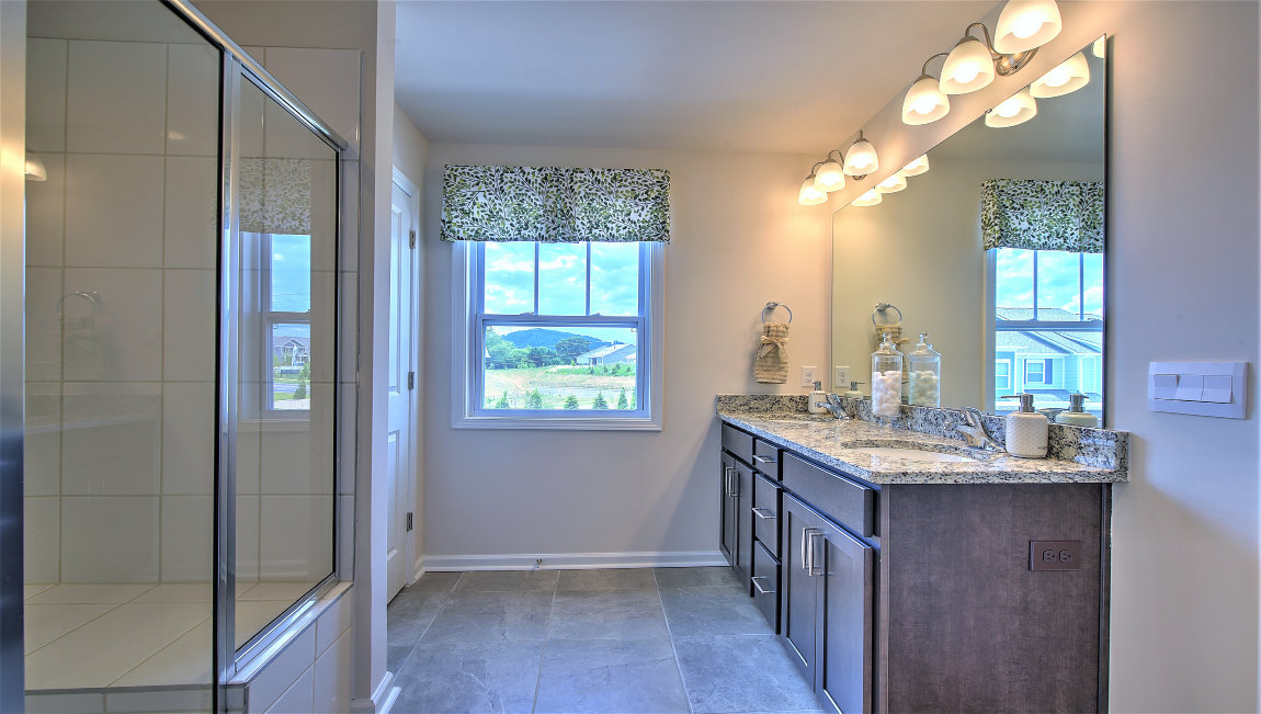 Bathroom with double sinks, glass door shower
