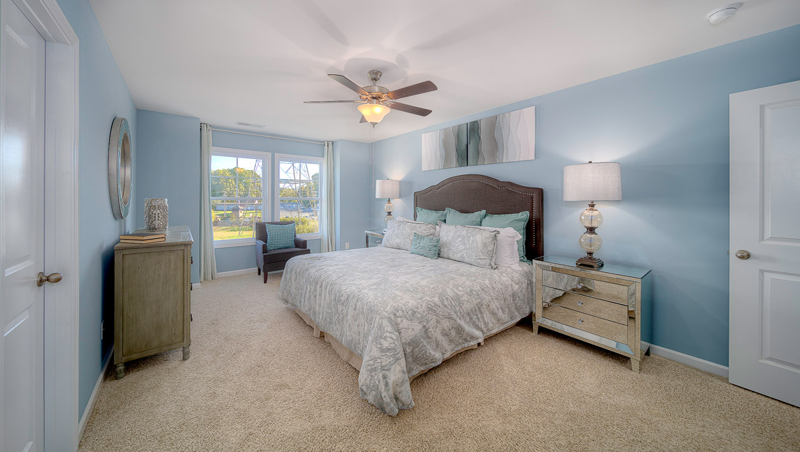 Primary bedroom with large windows