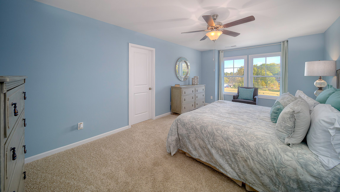 Carpeted bedroom with large windows