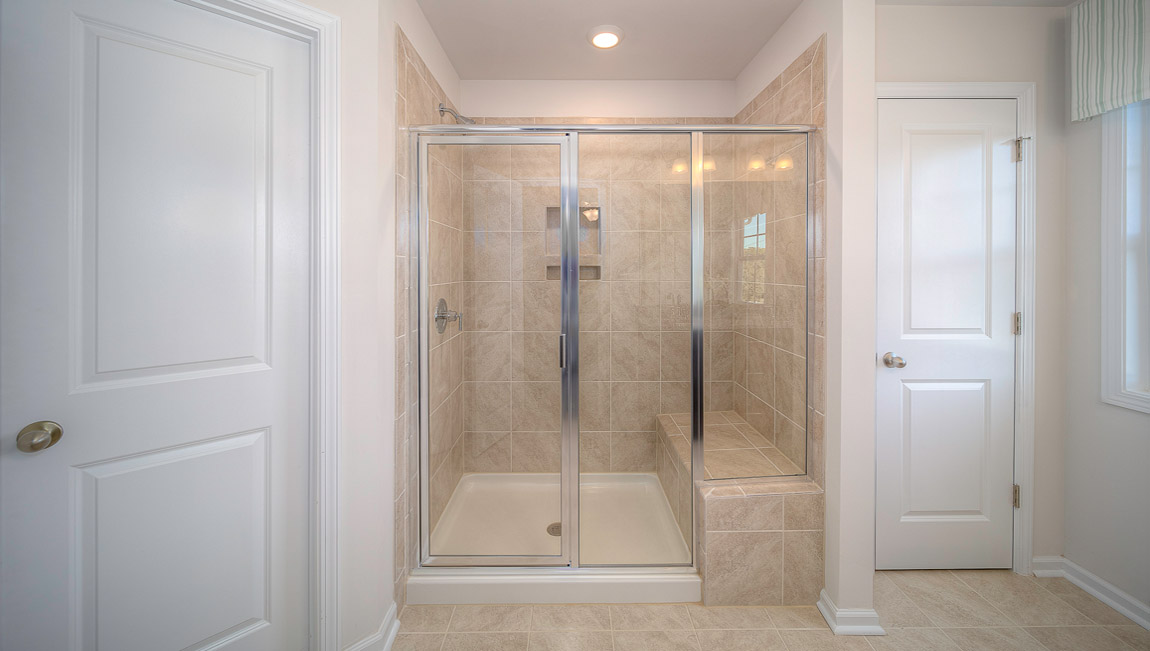 Bathroom with double sinks, glass door shower