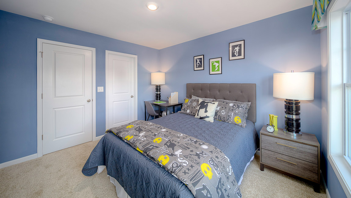 Carpeted bedroom with large windows