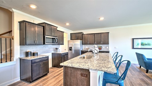 Open kitchen and island, with breakfast area, brown cabinets