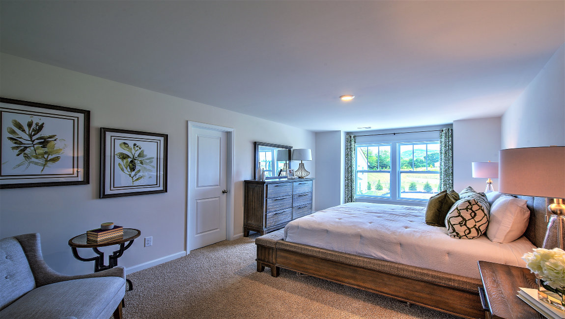 Carpeted bedroom with large windows