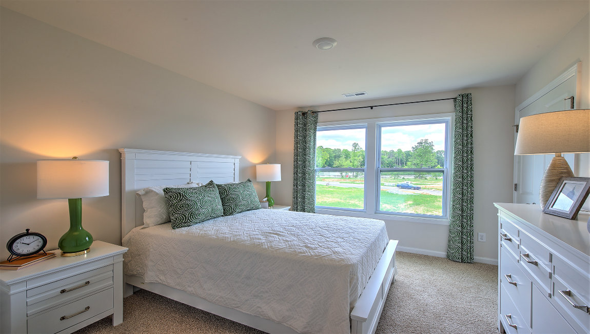 Carpeted bedroom with large windows