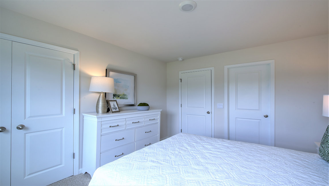 Carpeted bedroom with large windows