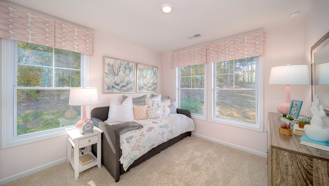 Carpeted bedroom with large windows