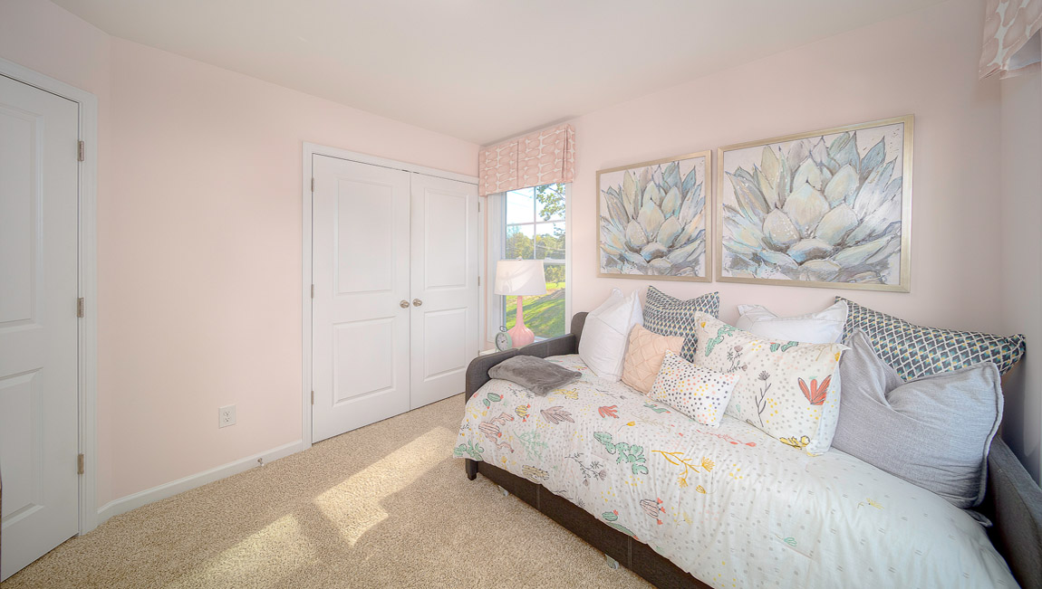 Carpeted bedroom with large windows