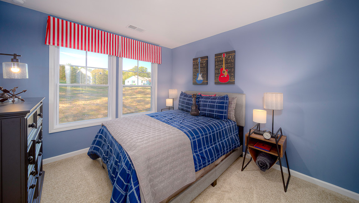 Carpeted bedroom with large windows