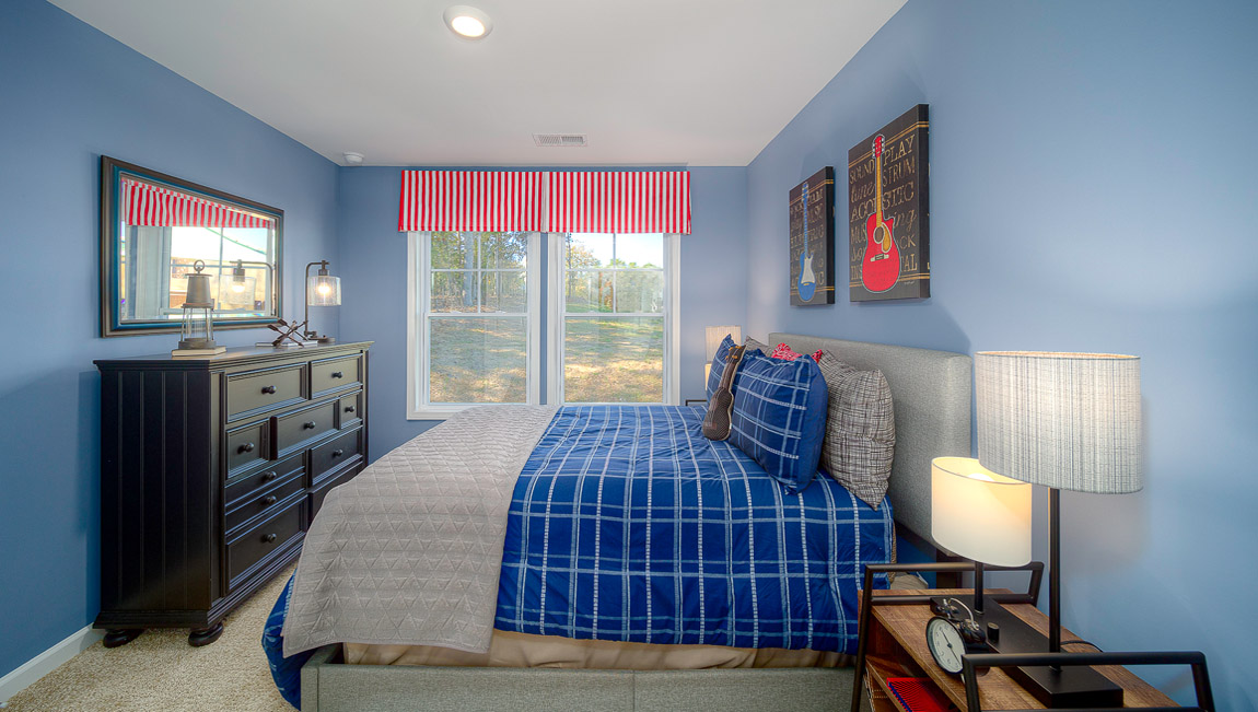 Carpeted bedroom with large windows