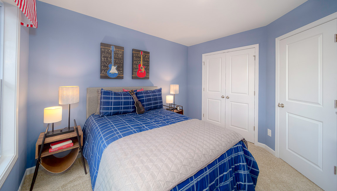 Carpeted bedroom with large windows
