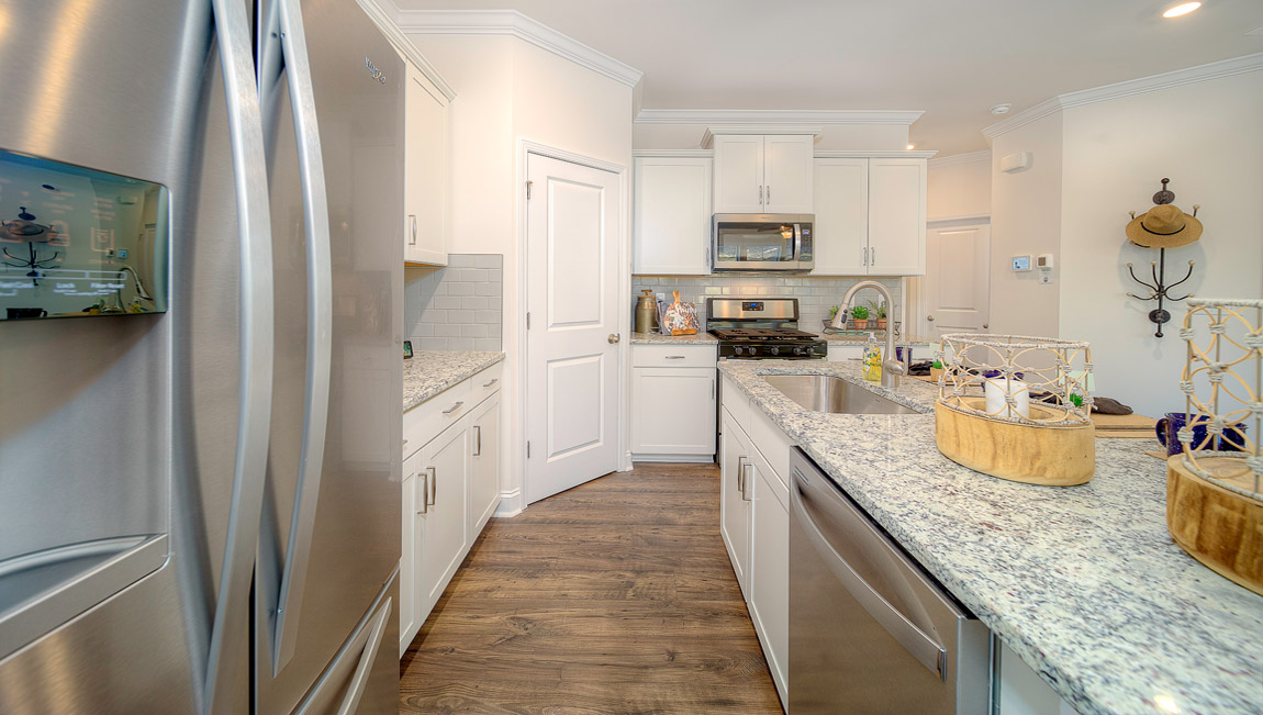 Open kitchen with island and stainless steel appliances
