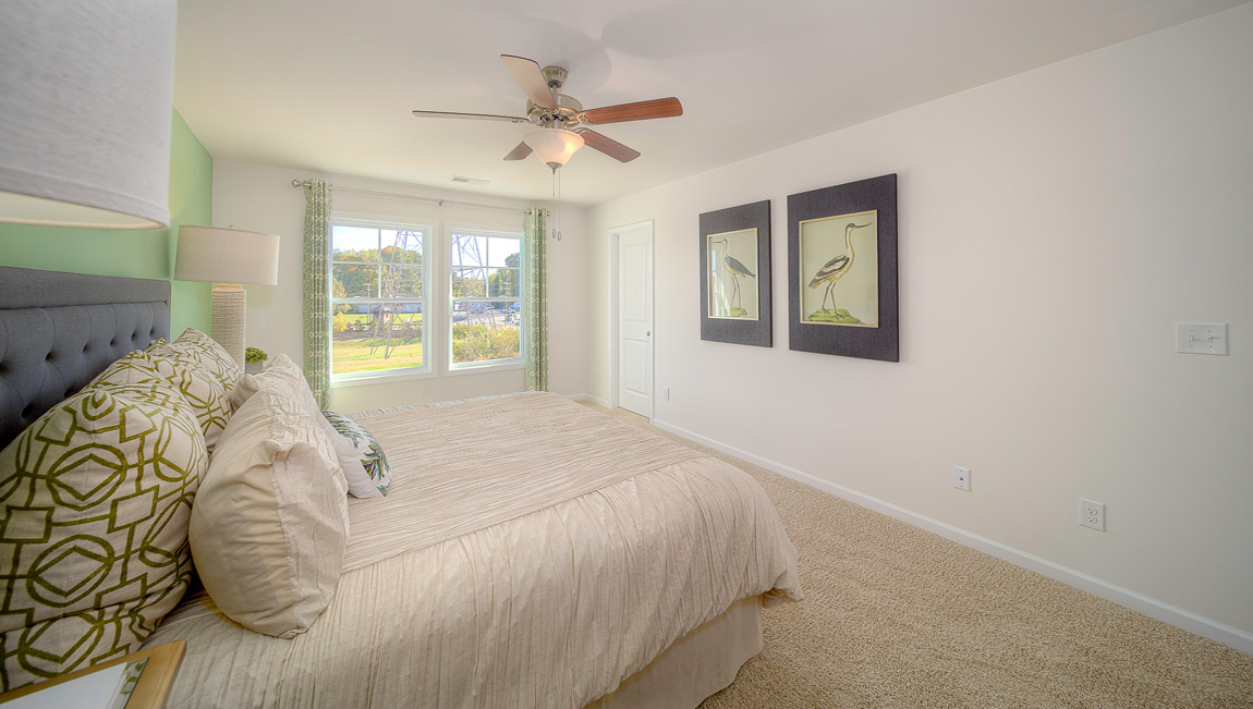 Primary bedroom with large windows
