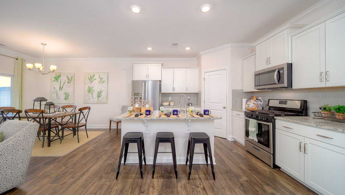 Open concept kitchen with island and stainless steel appliances