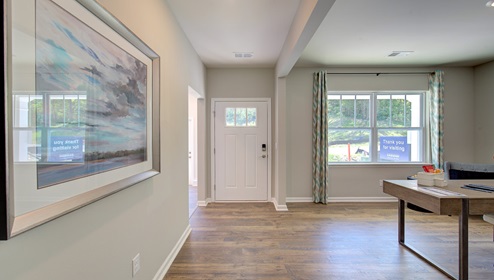 Welcoming foyer with large window beside flex space