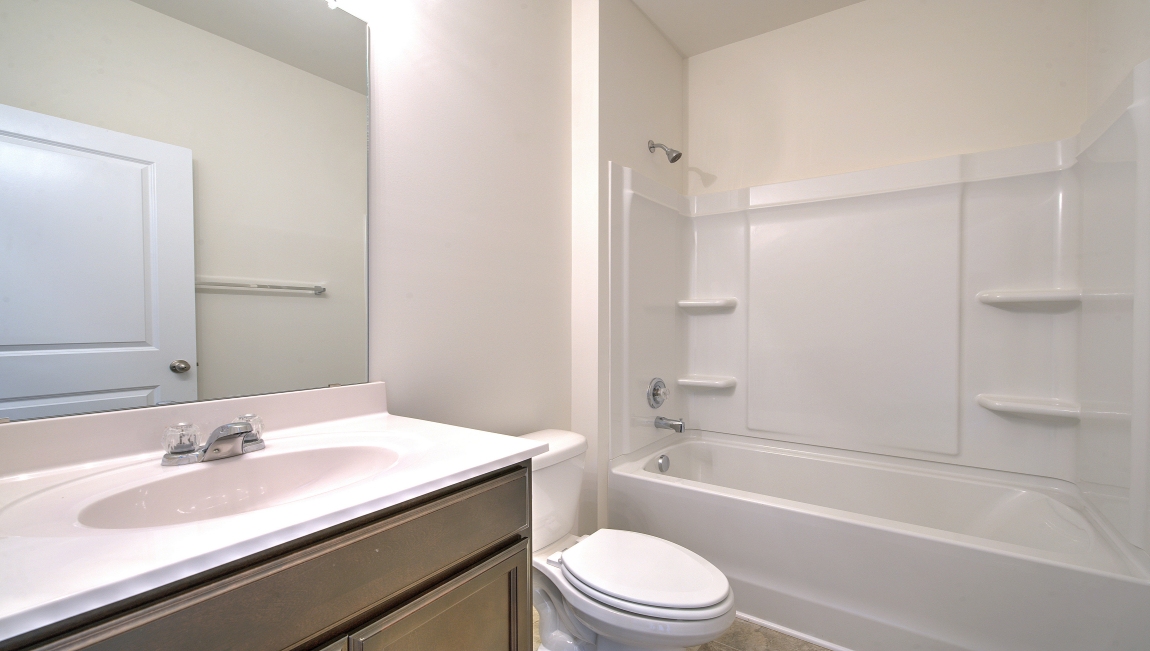 Carpeted bedroom with small window