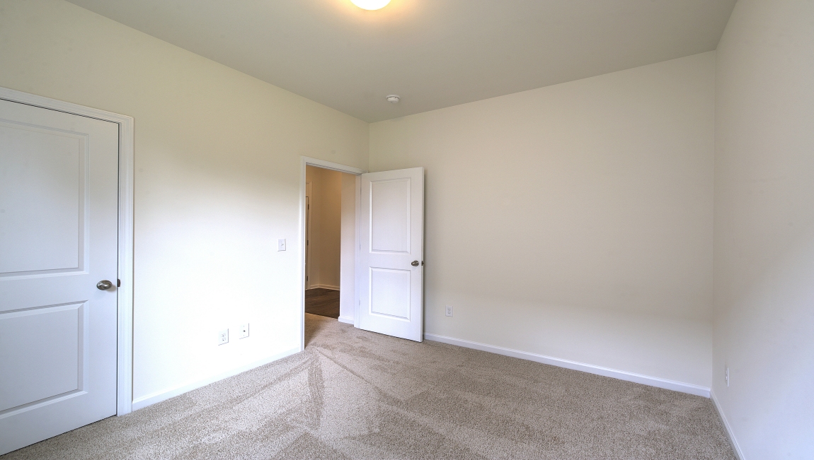 Carpeted bedroom with small window
