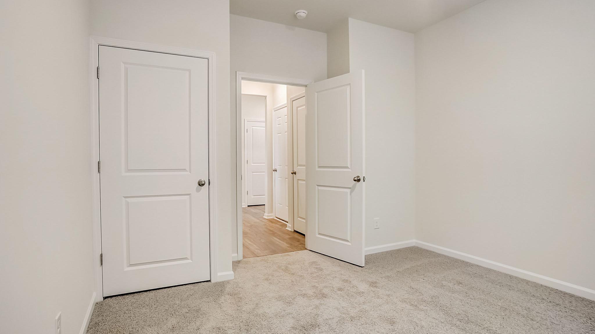 Carpeted bedroom with closet