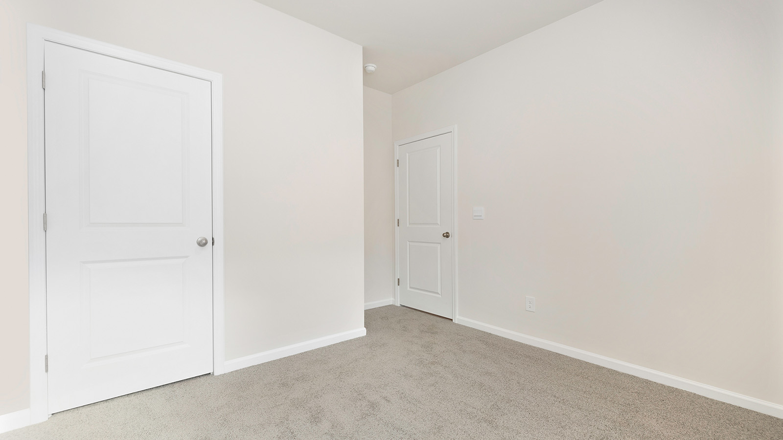 Carpeted bedroom with large window