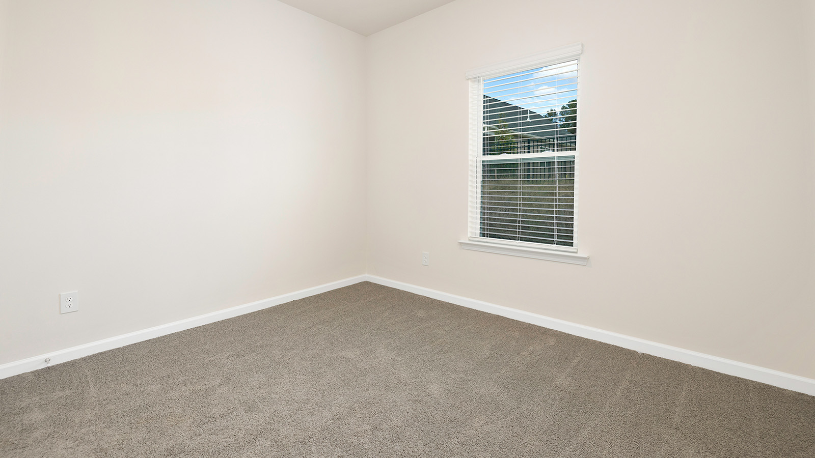 Carpeted bedroom with large window