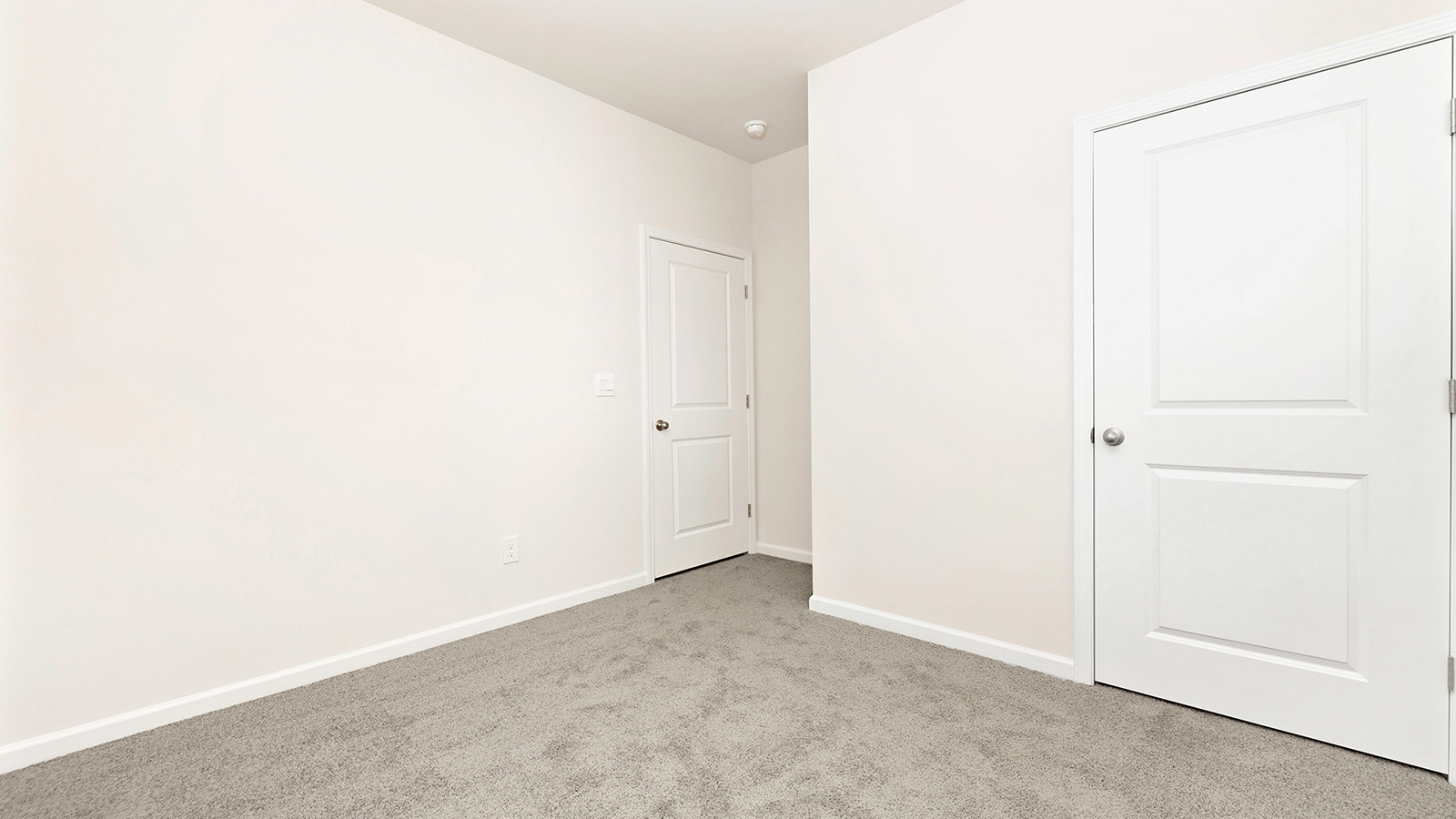 Carpeted bedroom with large window