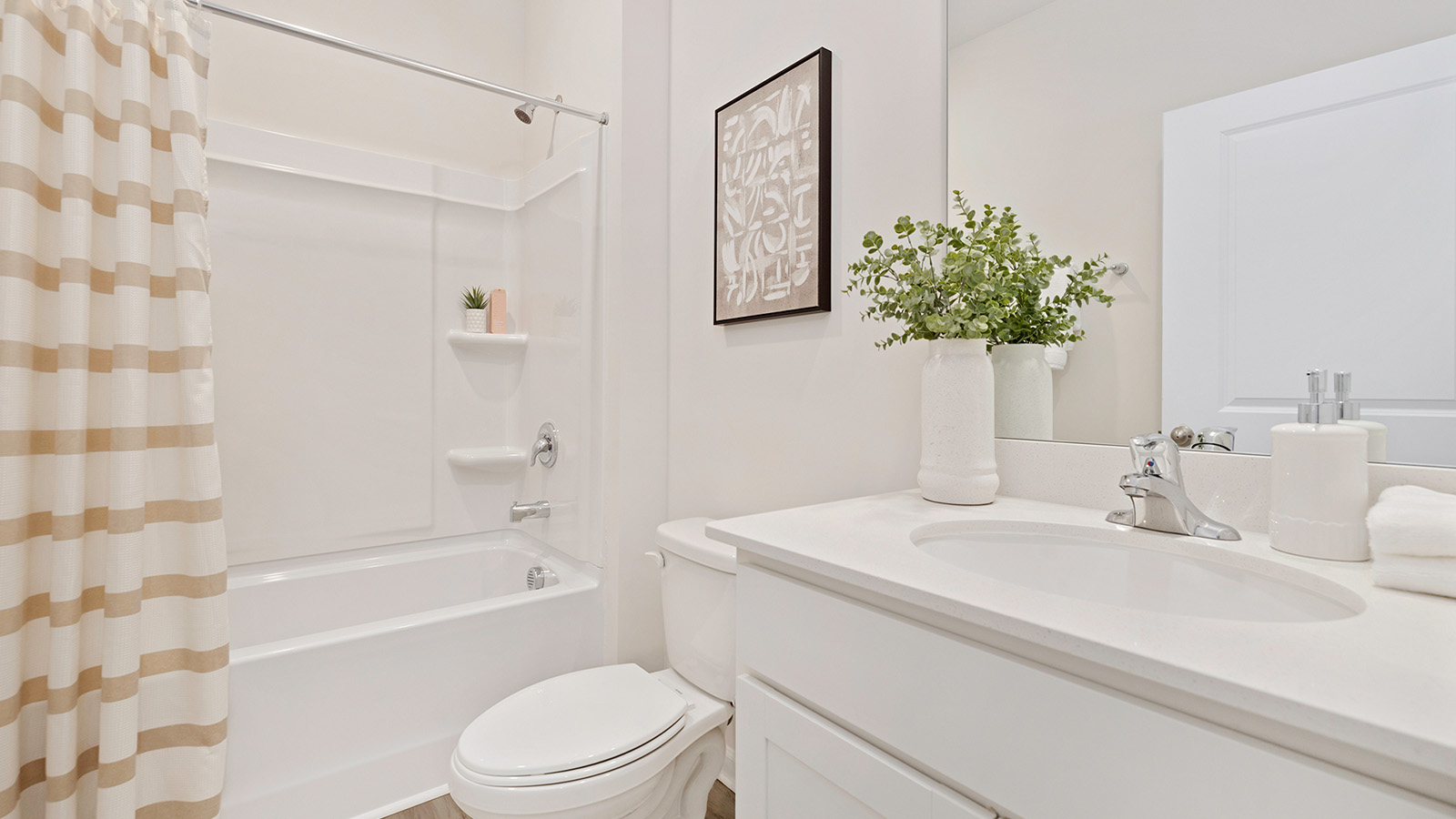 Bathroom with white cabinets and counters, and bathtub