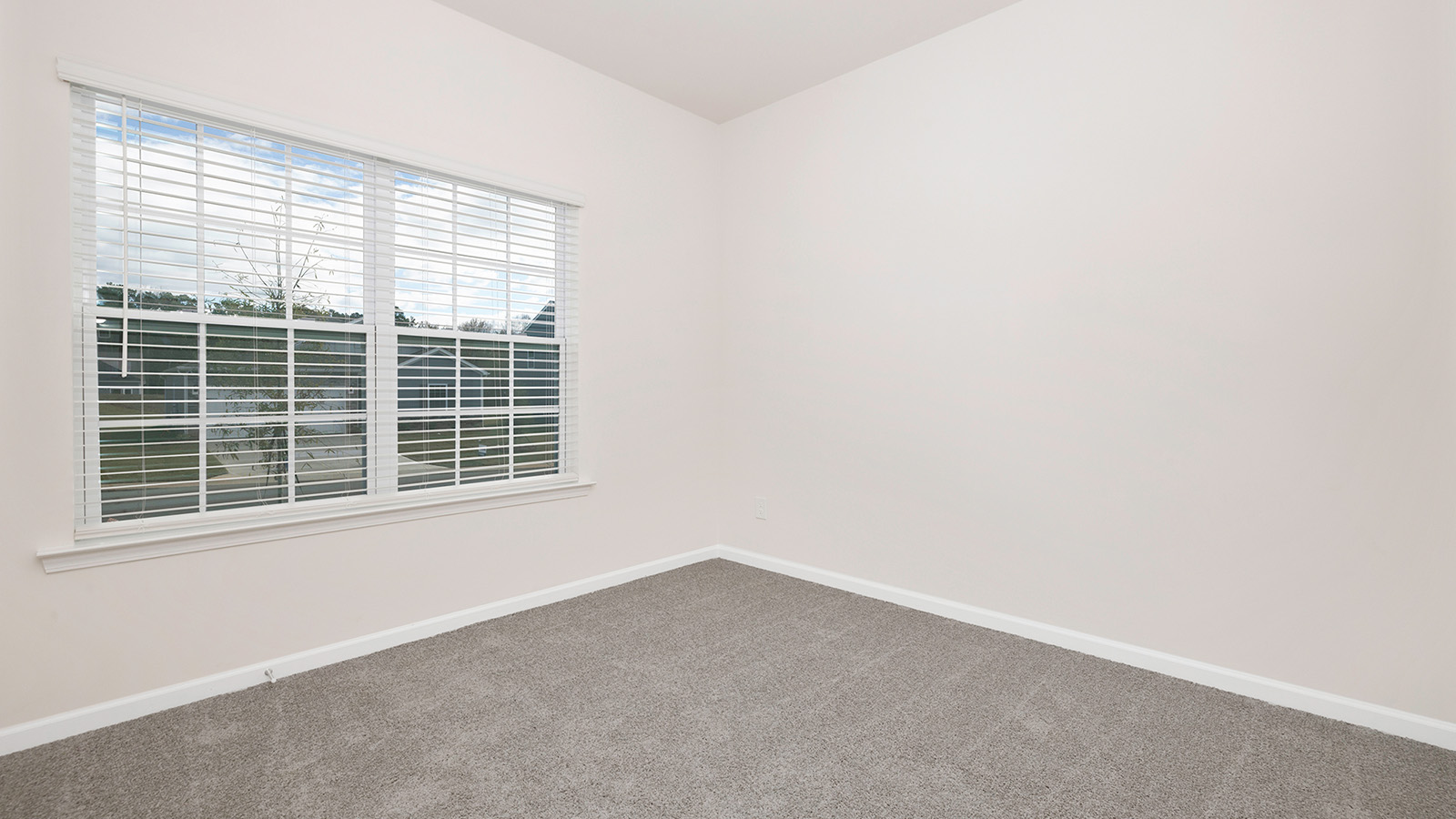 Carpeted bedroom with large window