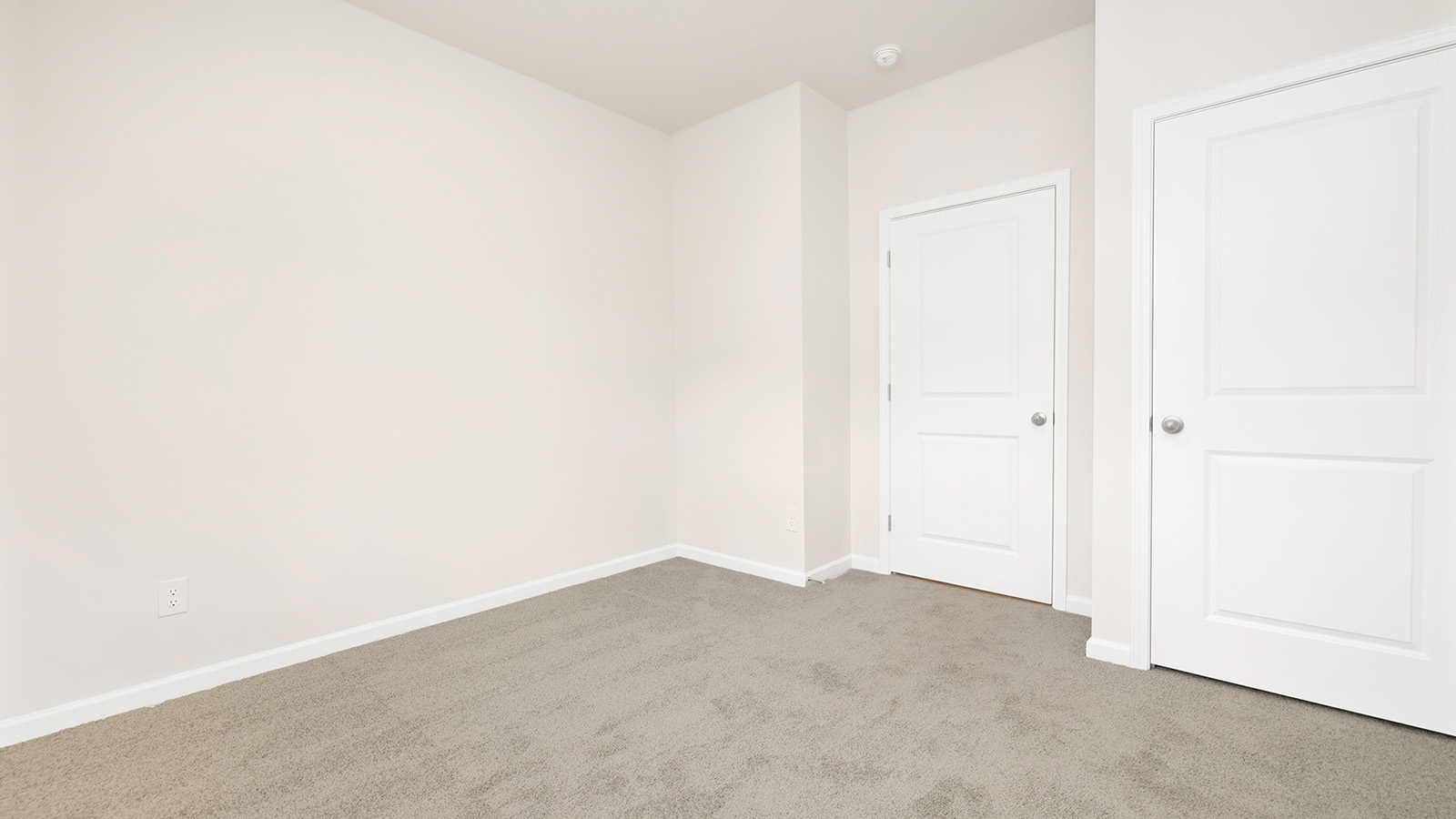 Carpeted bedroom with large window
