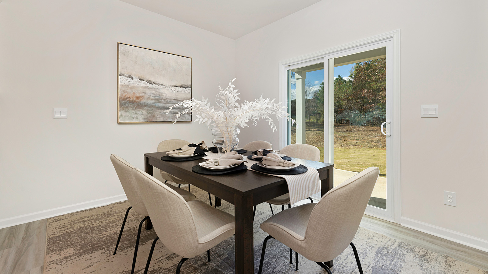 Dining area with wood floors and sliding glass back door