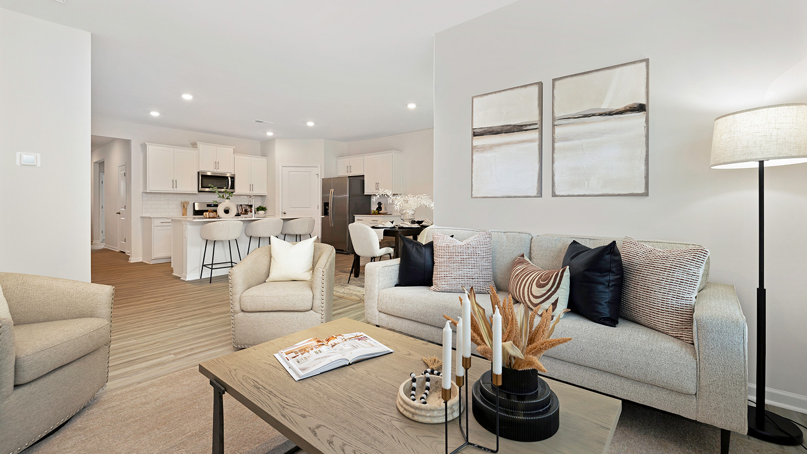 Open living room with wood floors, large window, and fireplace