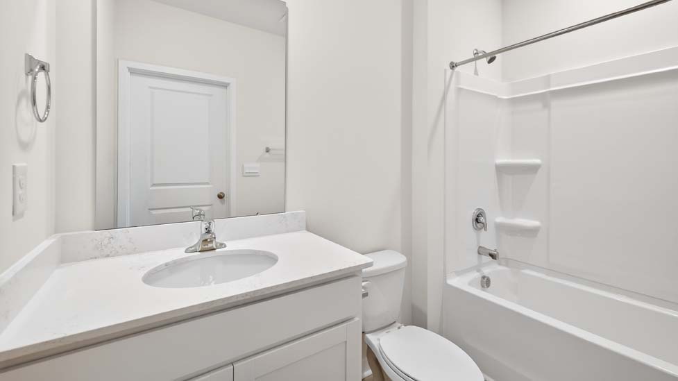 Bathroom with single vanity and bathtub