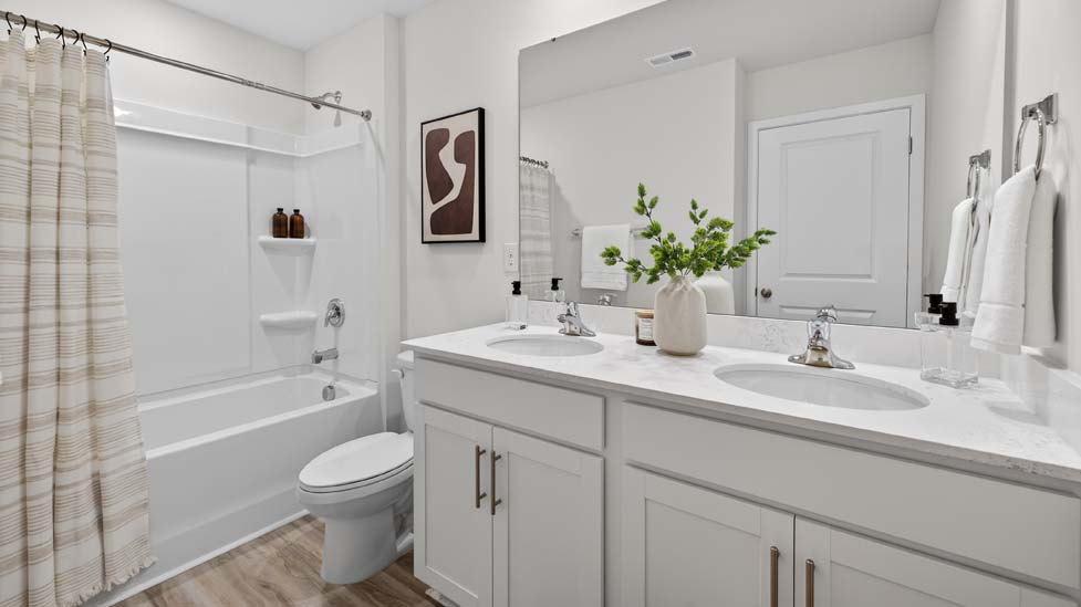 Bathroom with double vanity and bathtub