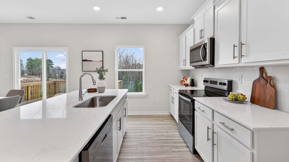 Open kitchen with island and stainless steel appliances