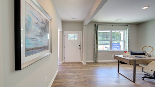 Welcoming foyer with large window beside flex space