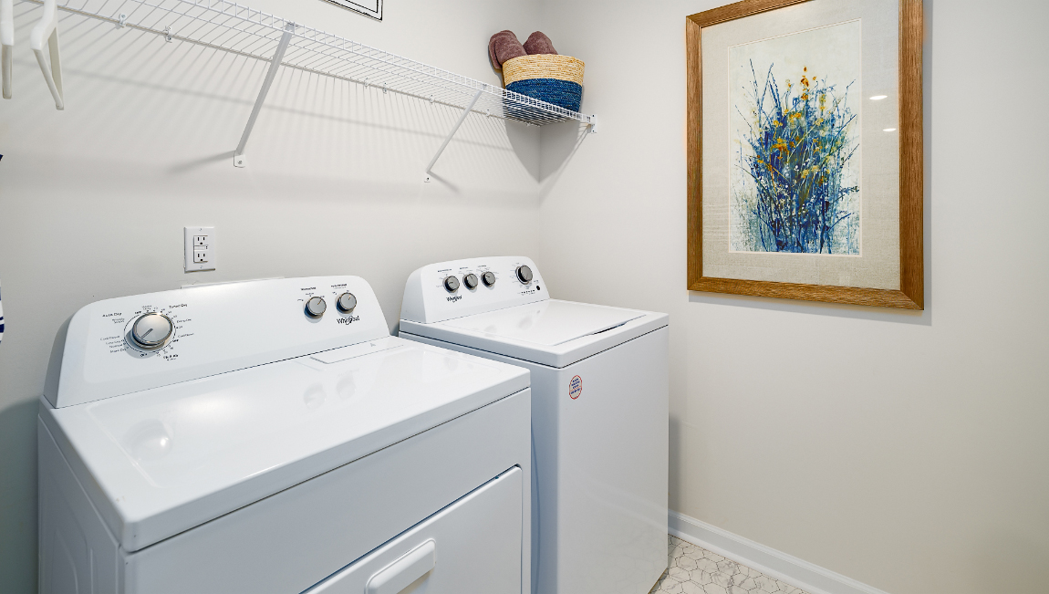Laundry Room with racks above machines